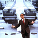 Toyota President Akio Toyoda showing off an old photo of a younger Pratt, working on a Toyota car.